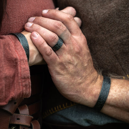 Close-up of Norse Heritage Ring and matching Viking bracelet with engraved Norse patterns by Ravenritual.